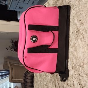 Like new used once Justice role travel bag